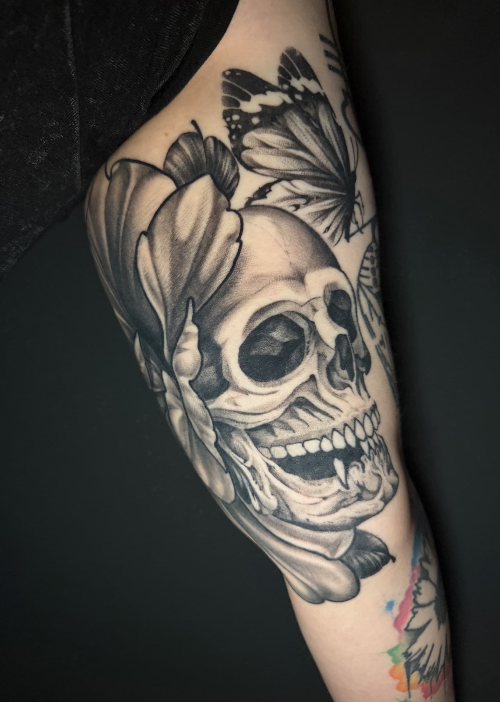 Healed black and grey butterfly tattoo by Pete Seyring.